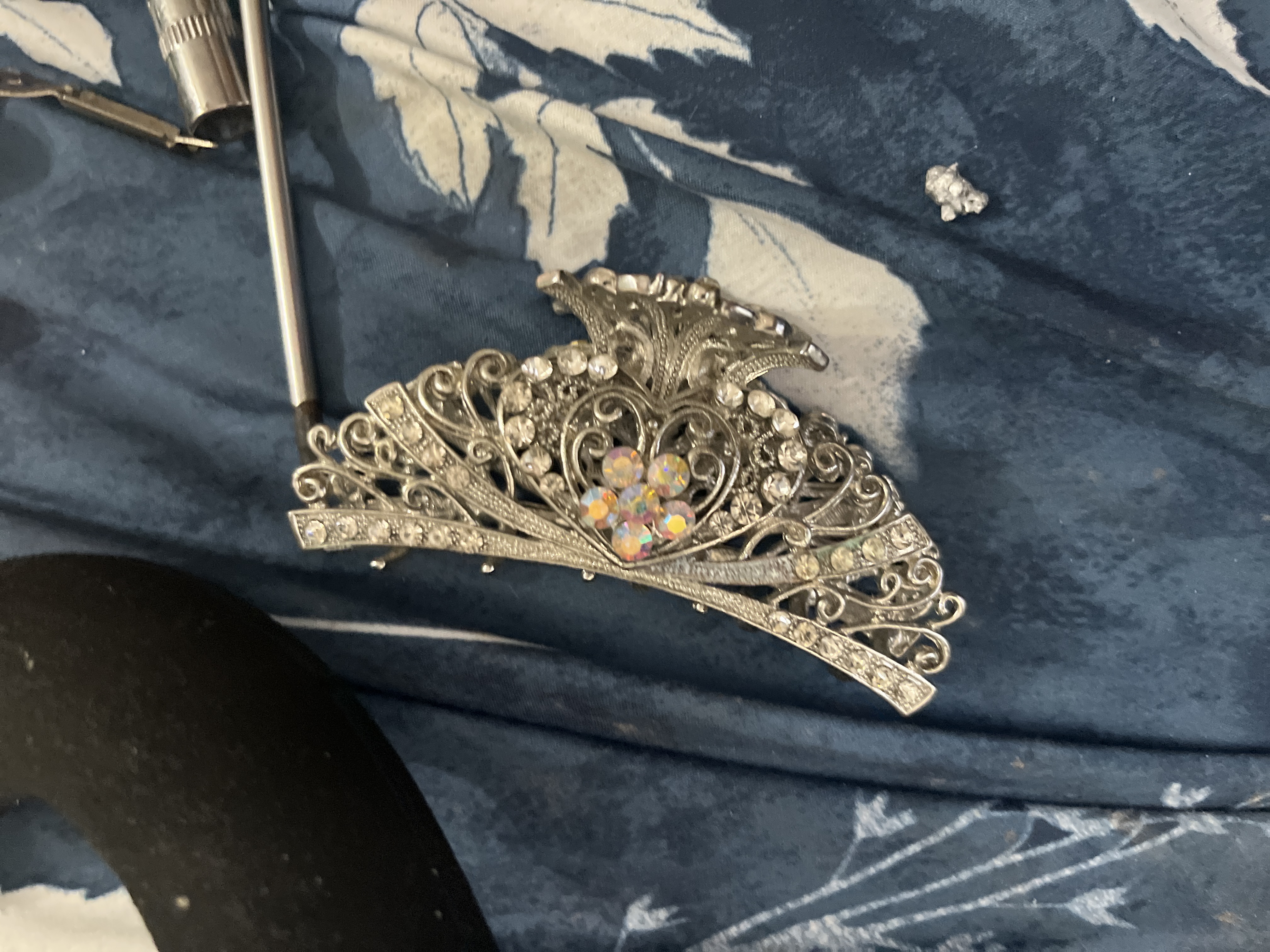Silver-tone articulated filigree bracelet with clear and aurora-borealis rhinestones; likely base-metal costume jewelry with simulated stones - AI says Fake